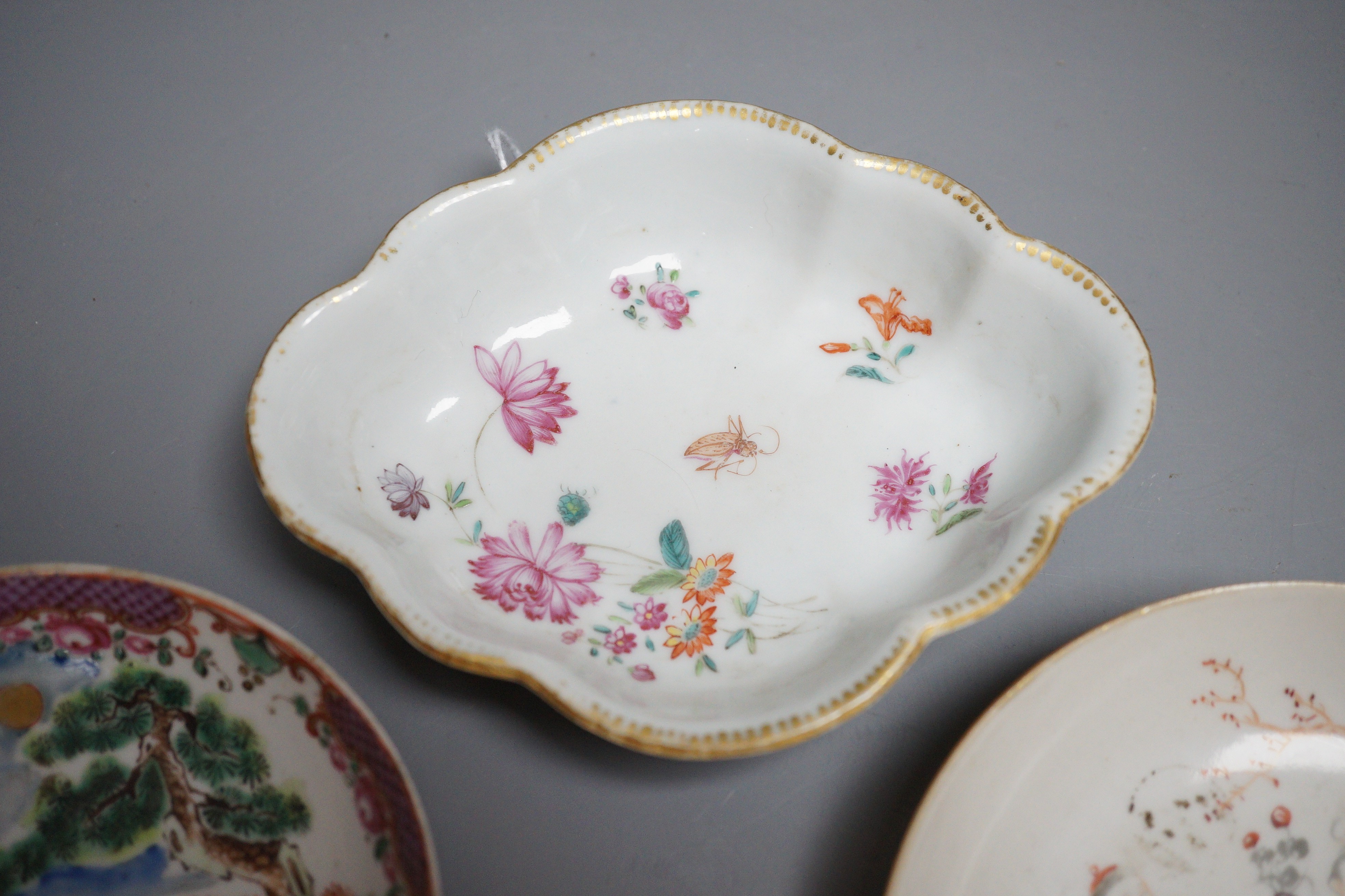 Two 18th century Chinese export saucers and two other later dishes, largest 13cm diameter